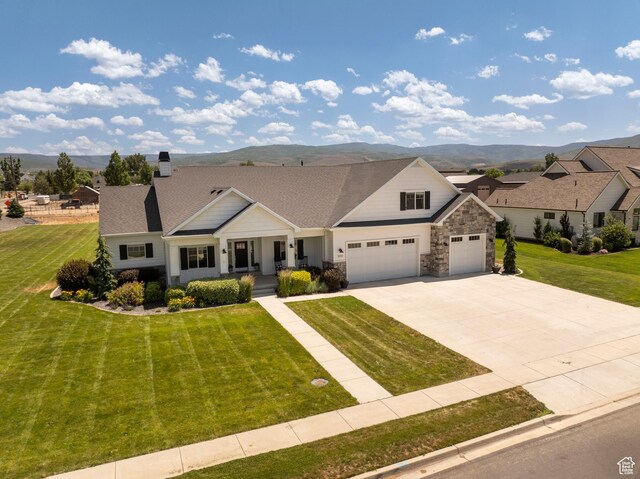1233 S 2240 E, Heber City, UT 84032 - view of front facade featuring covered porch, a mountain view, and a front yard