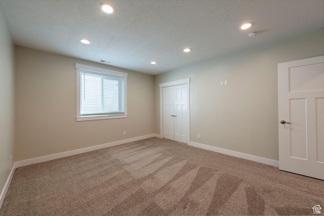 1233 S 2240 E, Heber City, UT 84032 - unfurnished bedroom featuring light colored carpet, recessed lighting, a textured ceiling, and a closet