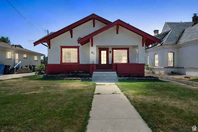 90 W 200 S, Logan, UT 84321 - view of front of house featuring a front lawn, stucco siding, and entry steps