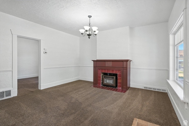 90 W 200 S, Logan, UT 84321 - unfurnished living room with carpet floors, a chandelier, a fireplace with flush hearth, and a textured ceiling