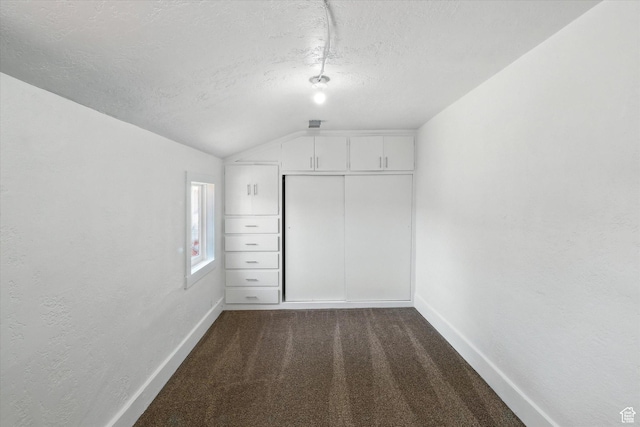 90 W 200 S, Logan, UT 84321 - unfurnished bedroom featuring vaulted ceiling, a textured ceiling, dark colored carpet, a closet, and a textured wall