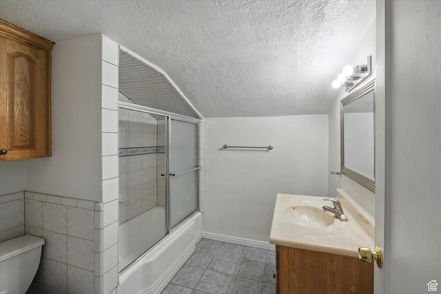90 W 200 S, Logan, UT 84321 - bathroom featuring a textured ceiling, vanity, tile patterned flooring, and combined bath / shower with glass door
