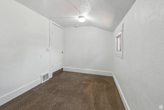 90 W 200 S, Logan, UT 84321 - empty room with lofted ceiling, dark carpet, and a textured ceiling