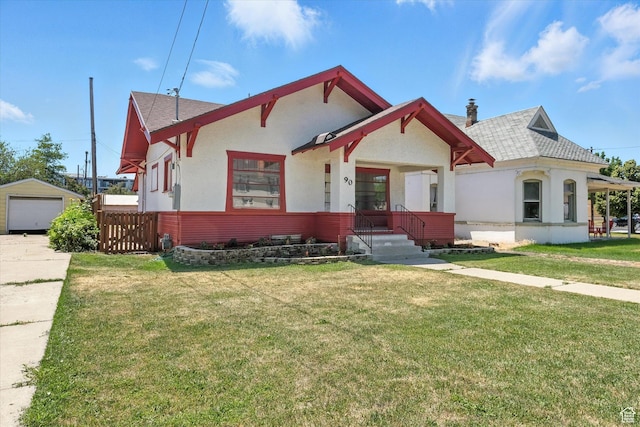 90 W 200 S, Logan, UT 84321 - view of front facade with a front yard, a detached garage, stucco siding, and roof with shingles