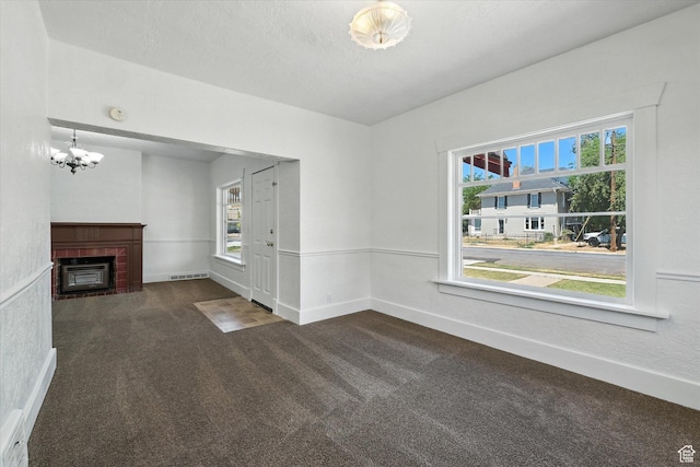 90 W 200 S, Logan, UT 84321 - unfurnished living room featuring carpet, a chandelier, and a fireplace
