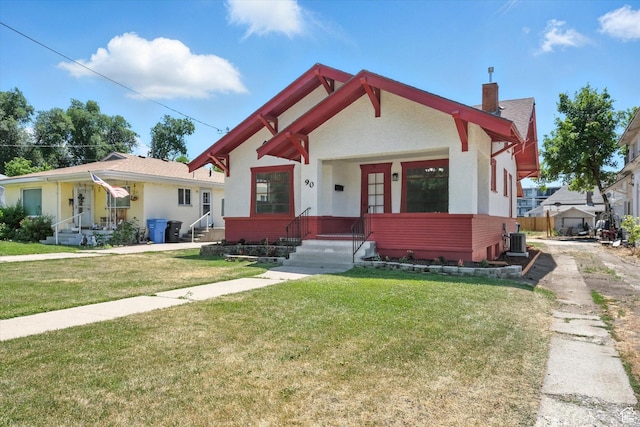 90 W 200 S, Logan, UT 84321 - view of front of house featuring a chimney, a front yard, and stucco siding