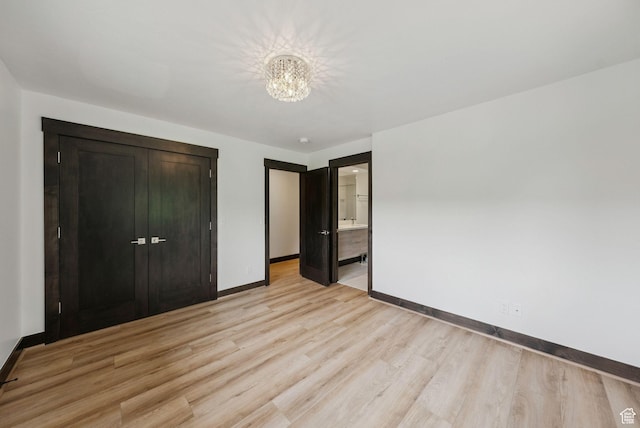 4670 Nelson Ct, Park City, UT 84098 - unfurnished bedroom with light wood-style flooring, a chandelier, a closet, and ensuite bathroom