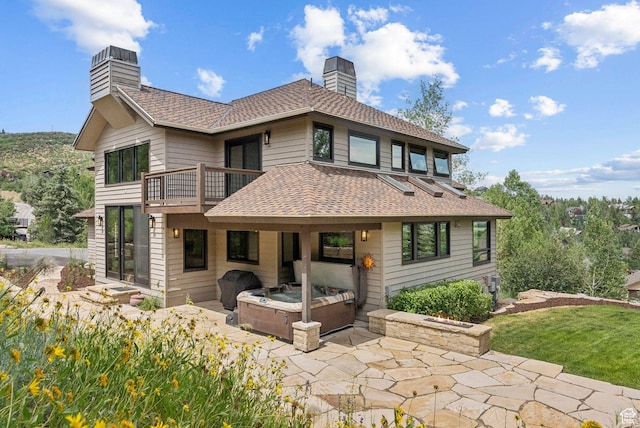 4670 Nelson Ct, Park City, UT 84098 - back of property with a chimney, a balcony, a patio, roof with shingles, and a hot tub