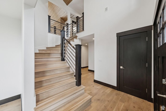 4670 Nelson Ct, Park City, UT 84098 - foyer entrance featuring stairs, light wood-style flooring, and a towering ceiling