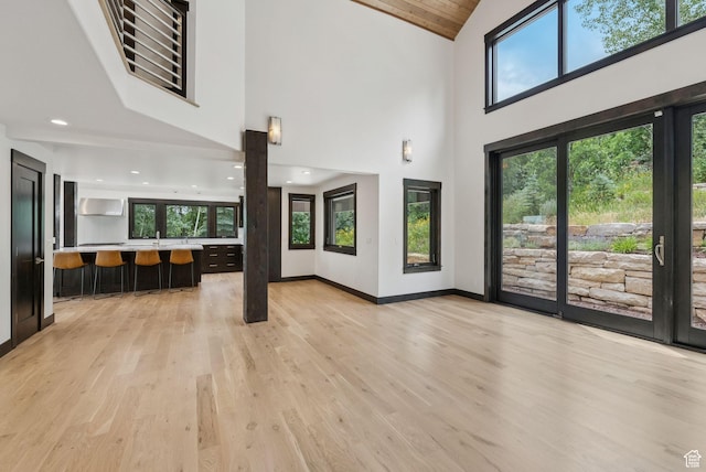 4670 Nelson Ct, Park City, UT 84098 - unfurnished living room featuring light wood-type flooring, high vaulted ceiling, and healthy amount of natural light