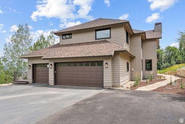 4670 Nelson Ct, Park City, UT 84098 - view of front facade featuring a chimney, asphalt driveway, an attached garage, and roof with shingles