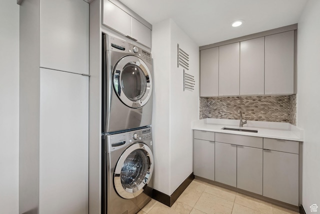 4670 Nelson Ct, Park City, UT 84098 - laundry room with stacked washer / dryer, cabinet space, light tile patterned flooring, and recessed lighting