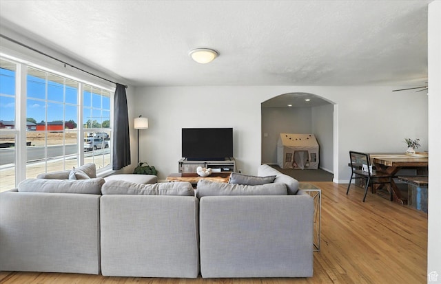 318 W 1300 N, Sunset, UT 84015 - living area featuring wood finished floors, arched walkways, and a ceiling fan