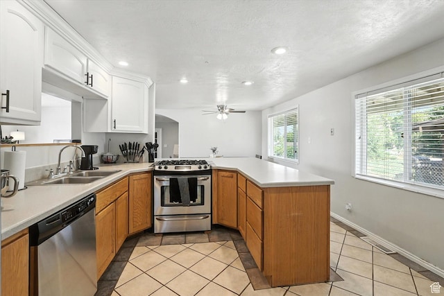 318 W 1300 N, Sunset, UT 84015 - kitchen featuring stainless steel appliances, a peninsula, ceiling fan, light countertops, and light tile patterned floors