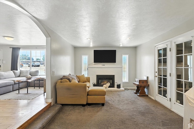 318 W 1300 N, Sunset, UT 84015 - carpeted living room featuring a textured ceiling, plenty of natural light, and a fireplace