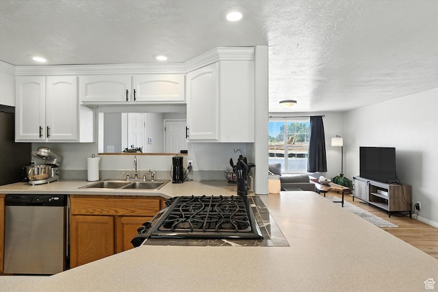 318 W 1300 N, Sunset, UT 84015 - kitchen featuring stainless steel dishwasher, range with gas cooktop, wood finished floors, light countertops, and white cabinets