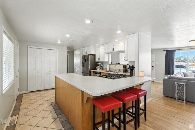 318 W 1300 N, Sunset, UT 84015 - kitchen featuring appliances with stainless steel finishes, white cabinetry, recessed lighting, light countertops, and a peninsula
