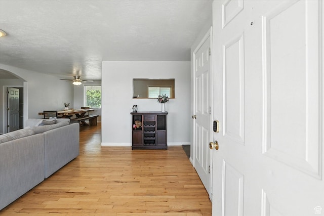 318 W 1300 N, Sunset, UT 84015 - living room featuring ceiling fan, light wood-style floors, and arched walkways