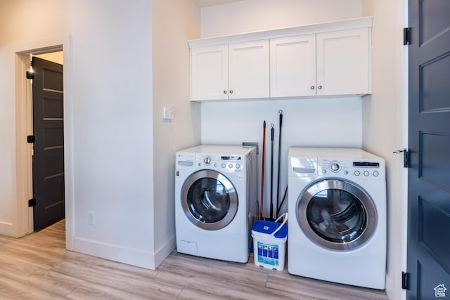 373 W Rendezvous Way N, Garden City, UT 84028 - laundry room with washing machine and clothes dryer, light wood-style flooring, and cabinet space