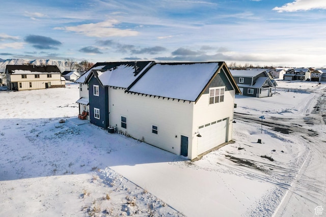 373 W Rendezvous Way N, Garden City, UT 84028 - view of snowy exterior with an attached garage and a residential view