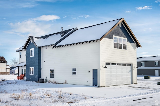 373 W Rendezvous Way N, Garden City, UT 84028 - view of snowy exterior featuring a garage and a central AC unit