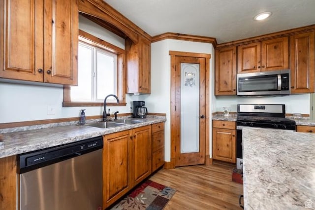 4178 E 5000 S, Vernal, UT 84078 - kitchen featuring appliances with stainless steel finishes, brown cabinets, light wood-style floors, light countertops, and recessed lighting