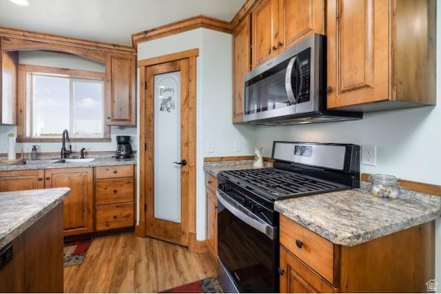 4178 E 5000 S, Vernal, UT 84078 - kitchen featuring stainless steel appliances, brown cabinets, and light wood-type flooring