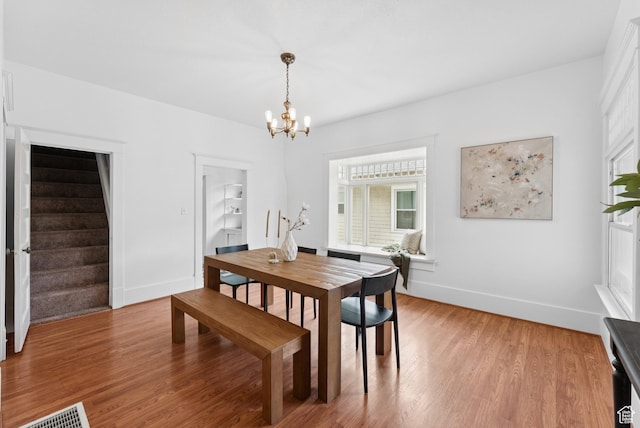 467 S 1300 E, Salt Lake City, UT 84102 - dining space with a chandelier, stairway, and light wood finished floors