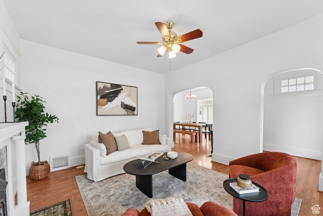 467 S 1300 E, Salt Lake City, UT 84102 - living area featuring arched walkways, plenty of natural light, ceiling fan, and a fireplace