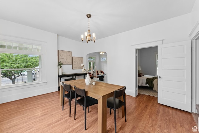 467 S 1300 E, Salt Lake City, UT 84102 - dining space with arched walkways, light wood-style floors, and a chandelier