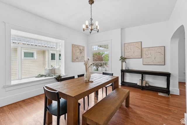 467 S 1300 E, Salt Lake City, UT 84102 - dining space with arched walkways, a chandelier, and wood finished floors