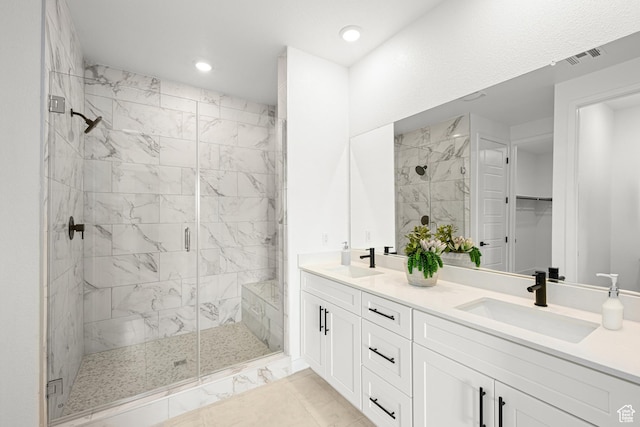578 S Cecita Way Unit 91, St George, UT 84770 - bathroom featuring marble finish flooring, a stall shower, double vanity, recessed lighting, and a walk in closet