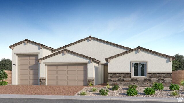 578 S Cecita Way Unit 91, St George, UT 84770 - view of front of home with stone siding, a garage, stucco siding, and driveway