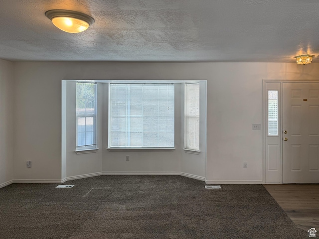 1356 S 1400 E, Provo, UT 84606 - unfurnished room featuring a textured ceiling, dark colored carpet, and dark wood-style floors