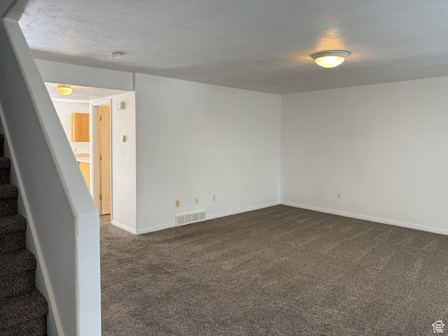 1356 S 1400 E, Provo, UT 84606 - empty room with a textured ceiling, dark colored carpet, and stairs