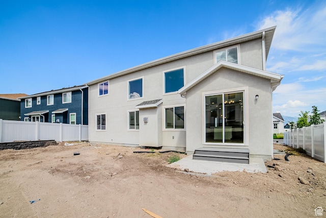 10942 S Samoa Dune Dr, South Jordan, UT 84009 - rear view of house featuring stucco siding and entry steps