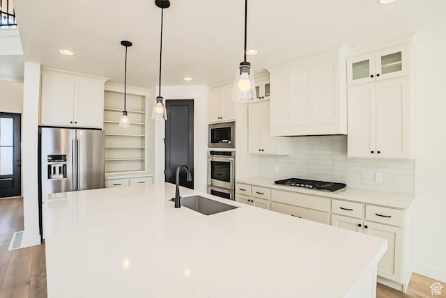 10942 S Samoa Dune Dr, South Jordan, UT 84009 - kitchen featuring appliances with stainless steel finishes, an island with sink, decorative backsplash, white cabinets, and recessed lighting