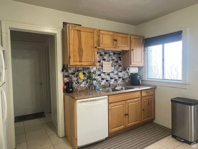 7659 S Lincoln St, Midvale, UT 84047 - kitchen featuring white dishwasher, light tile patterned floors, tasteful backsplash, and brown cabinets