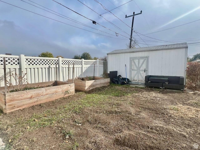 7659 S Lincoln St, Midvale, UT 84047 - view of yard with a vegetable garden and a storage unit