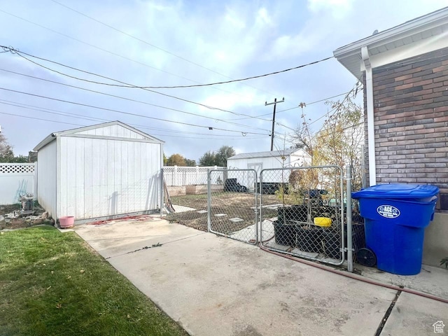 7659 S Lincoln St, Midvale, UT 84047 - view of patio featuring a storage unit and a gate