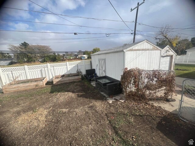 7659 S Lincoln St, Midvale, UT 84047 - view of yard featuring a storage shed and a garage