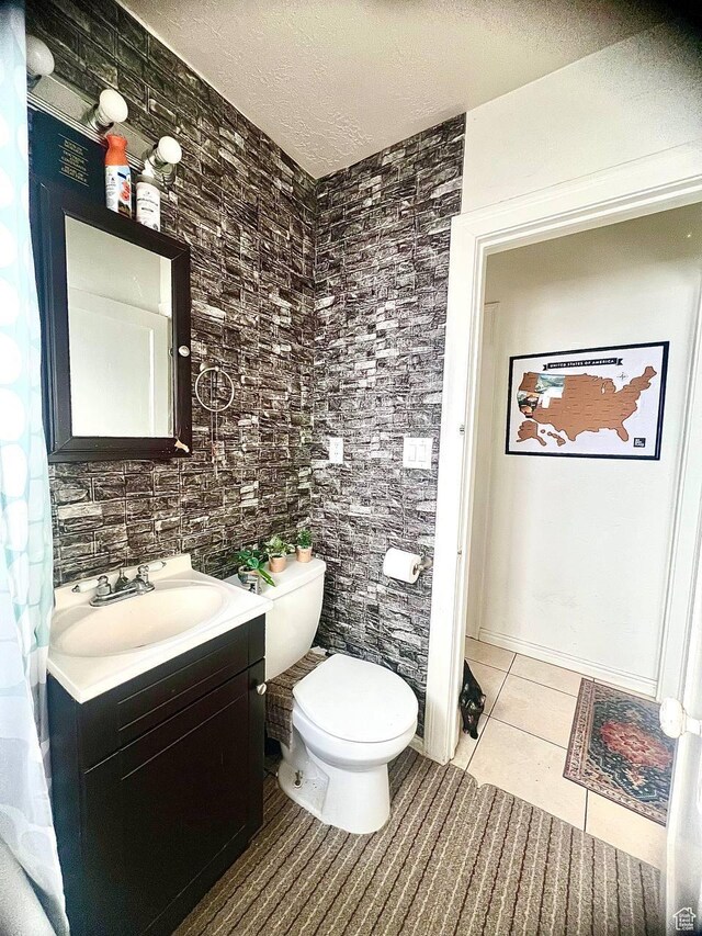 7659 S Lincoln St, Midvale, UT 84047 - bathroom featuring tile patterned flooring, vanity, and a textured ceiling