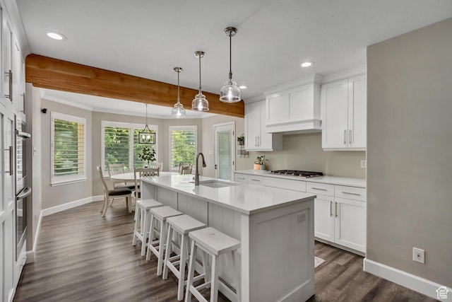6063 S Kamas Dr W, Taylorsville, UT 84129 - kitchen featuring stainless steel gas stovetop, light countertops, dark wood-style flooring, recessed lighting, and white cabinetry