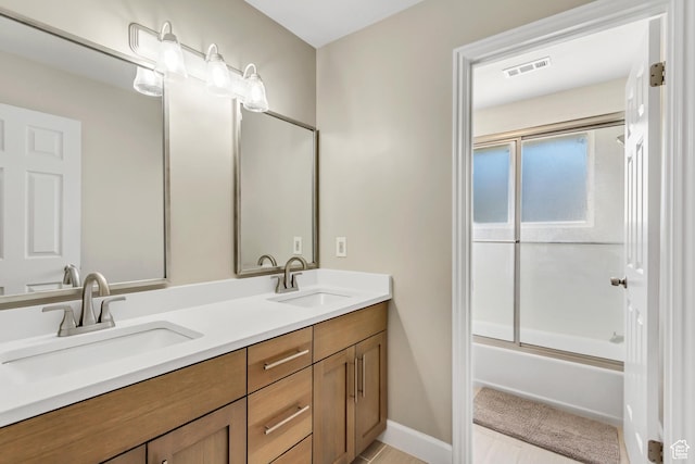 6063 S Kamas Dr W, Taylorsville, UT 84129 - bathroom with double vanity and enclosed tub / shower combo