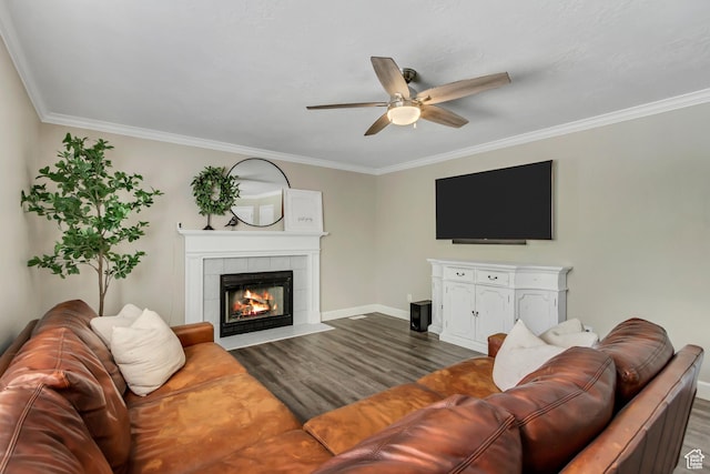 6063 S Kamas Dr W, Taylorsville, UT 84129 - living area with a tiled fireplace, dark wood-style floors, a ceiling fan, and crown molding