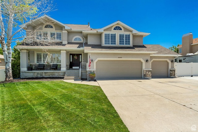 6063 S Kamas Dr W, Taylorsville, UT 84129 - view of front of home featuring stucco siding, concrete driveway, covered porch, stone siding, and a garage