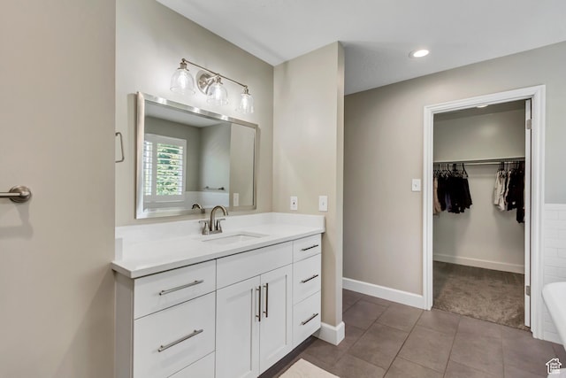 6063 S Kamas Dr W, Taylorsville, UT 84129 - full bathroom with vanity, a spacious closet, tile patterned flooring, and recessed lighting