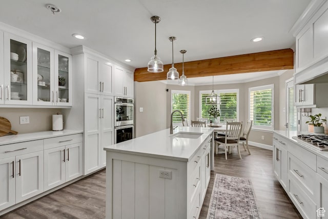 6063 S Kamas Dr W, Taylorsville, UT 84129 - kitchen with stainless steel appliances, light countertops, dark wood-type flooring, white cabinets, and recessed lighting