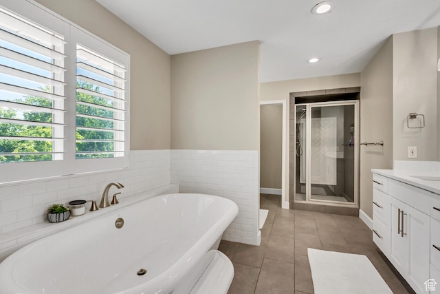 6063 S Kamas Dr W, Taylorsville, UT 84129 - bathroom featuring vanity, a soaking tub, a stall shower, tile patterned floors, and recessed lighting