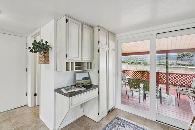 1074 E Spring Ridge Dr, Sandy, UT 84094 - kitchen featuring light tile patterned flooring, an office area, and dark countertops